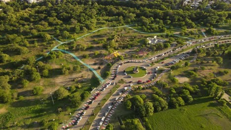 aerial view of colored street with parking cars surrounded by green nature of argentina