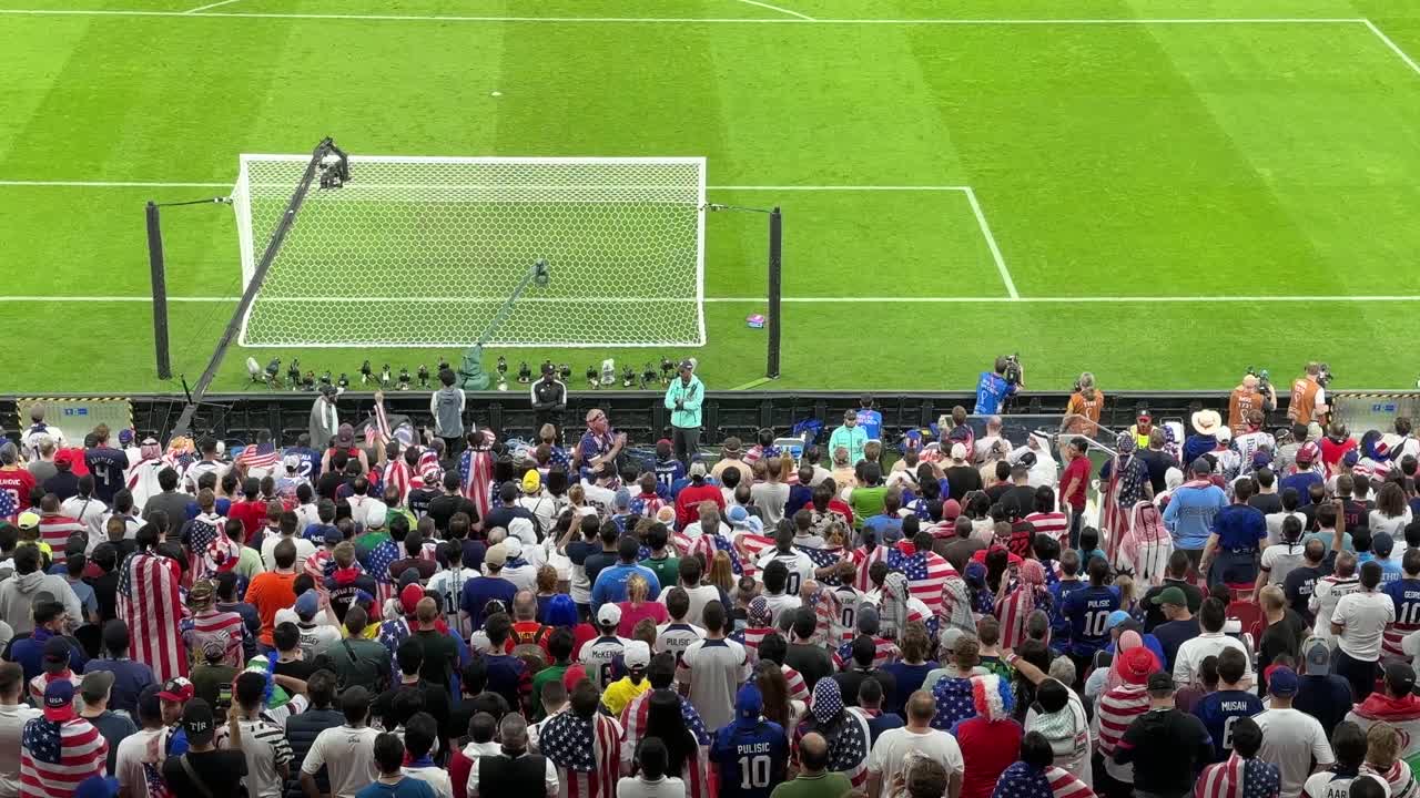 Football fans chanting happily support football team USA couple family friends sit in seat back of the gate applaud relax in a scenic view wide angel camera is recording Birdseye in the stadium