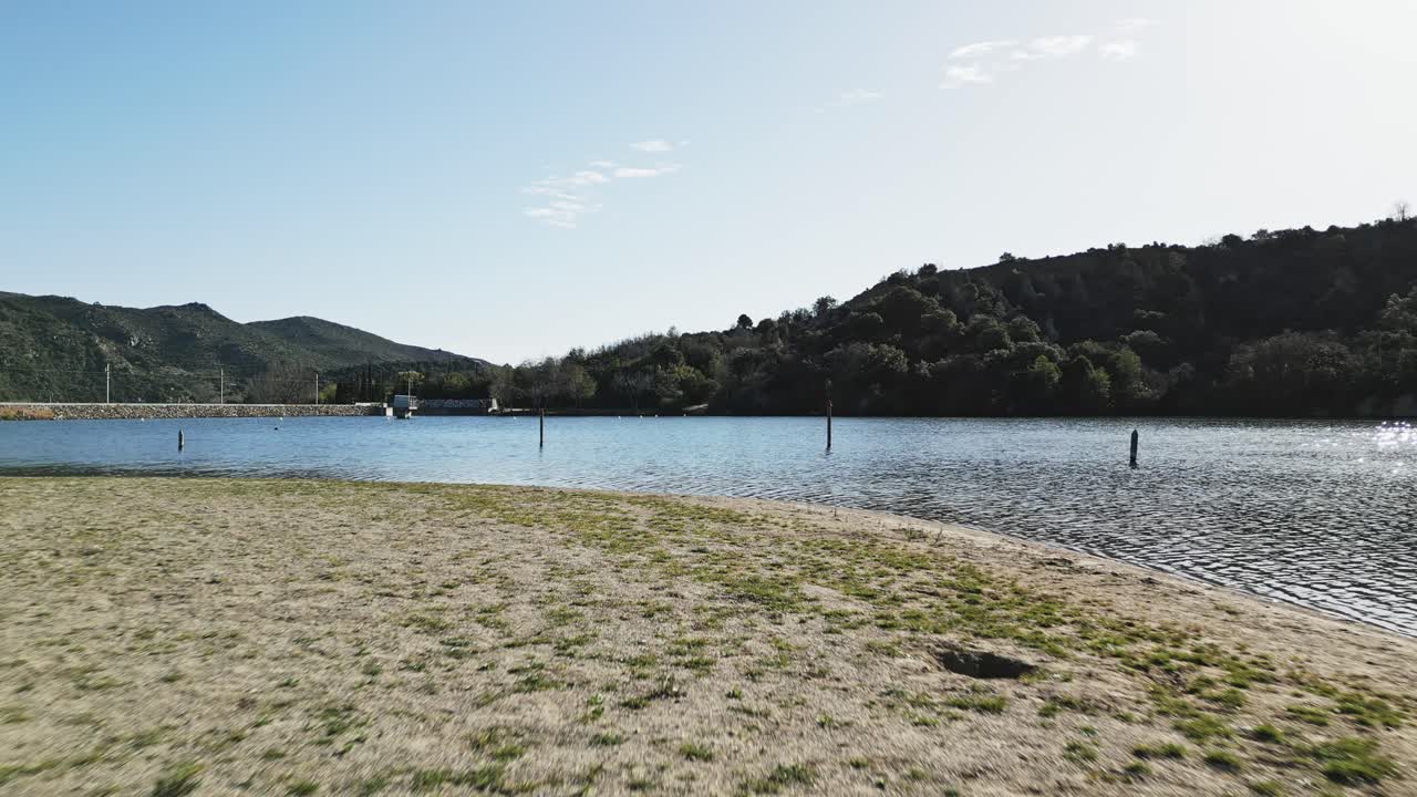 Drone footage of the water and ground at the lake Vin&ccedil;a in Southern France
