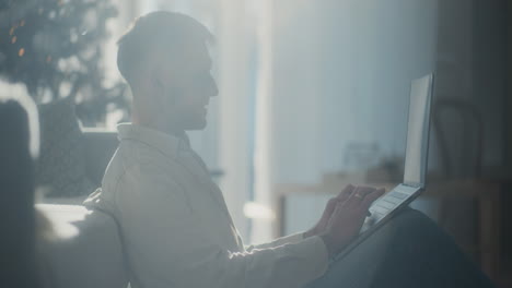 man makes credit card payments and online purchases on a laptop