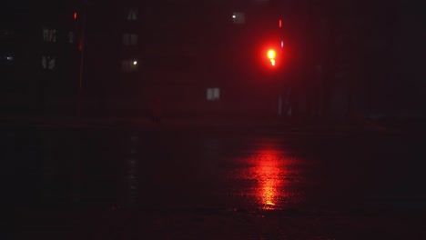 blurred lights of cars and traffic lights on a city street at night.