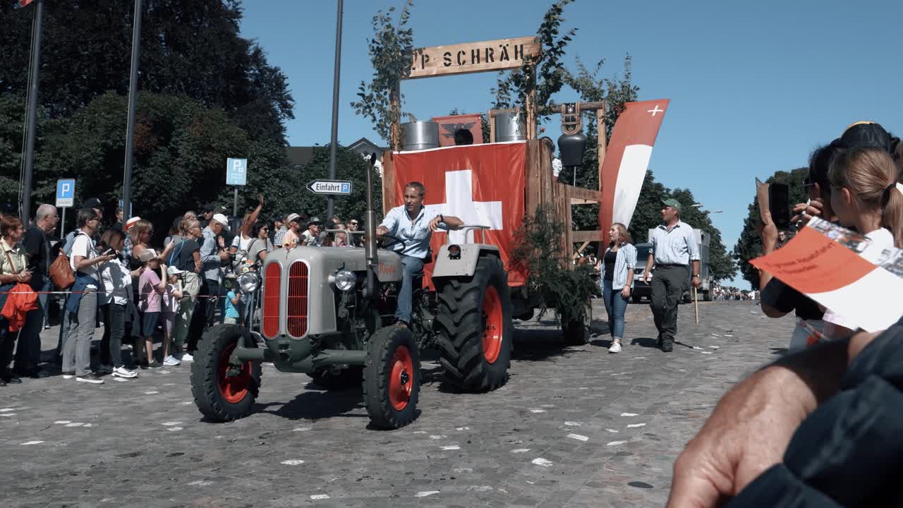 You can see the traditional alpine descent of the cows with the farmers. The cows walk next to the tractor from the alp down into the stable