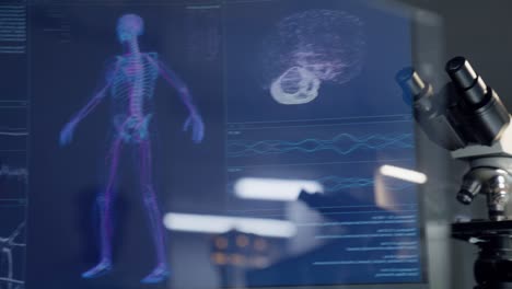 equipment reflecting in screens. detailed skeleton models on computer screen. looking for injury. futuristic laboratory research