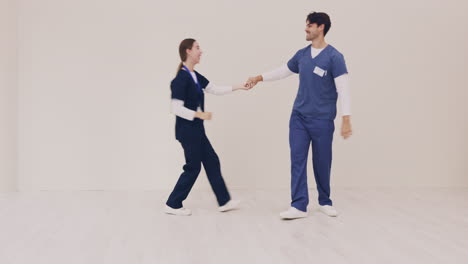 couple, smile and nurse dancing together