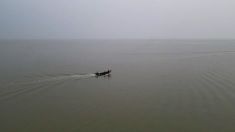 fishing engine trawler boat in the ocean on a cloudy day - drone shot