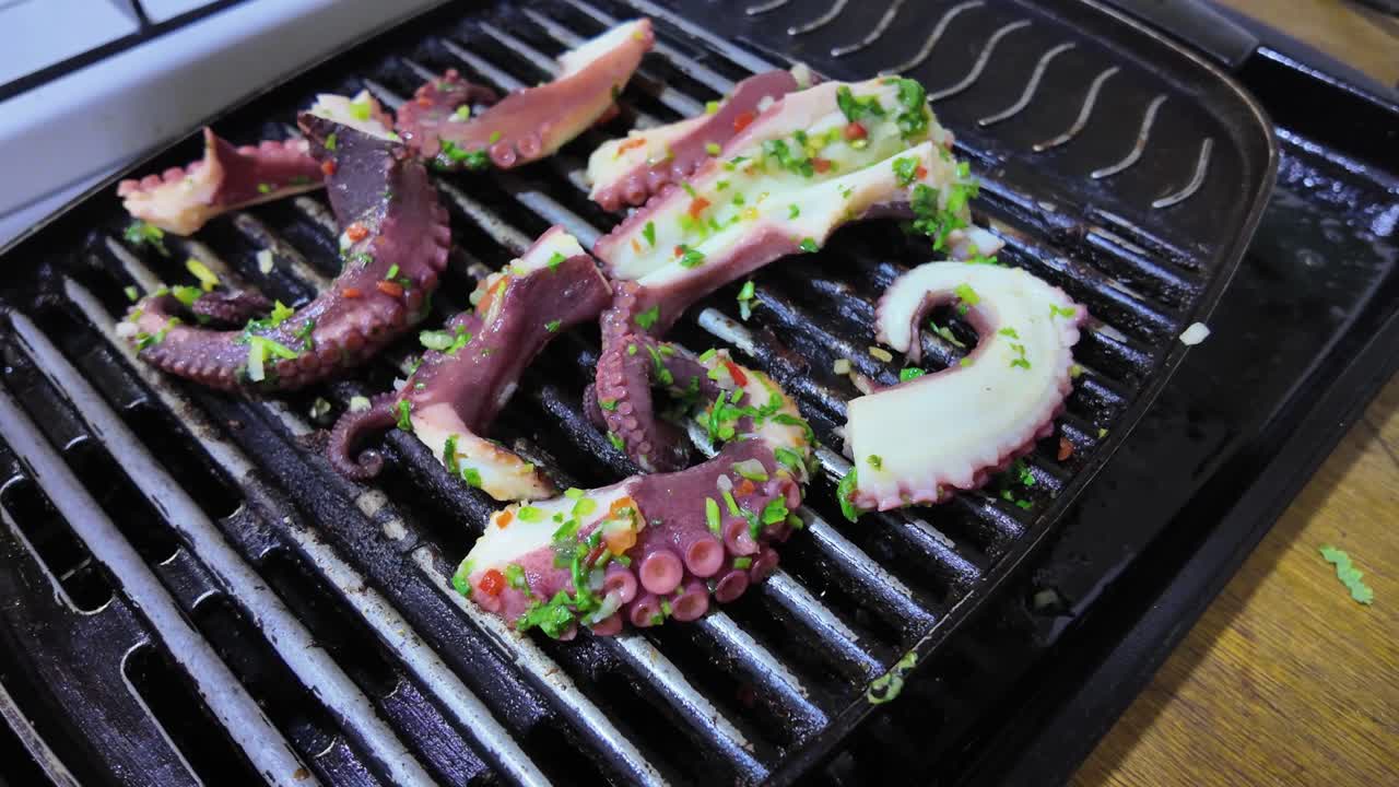 Grilled octopus tentacles seasoned with herbs and spices. Healthy food zoom out