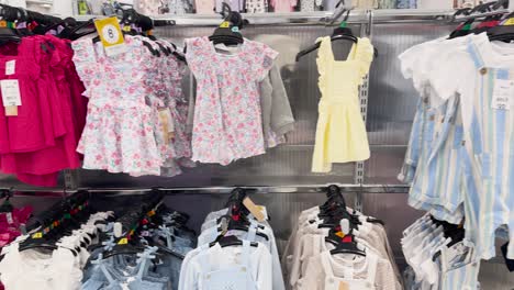 colorful children's clothes arranged on store racks