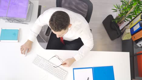 Relax.-Yawning-businessman-relaxing-in-office.