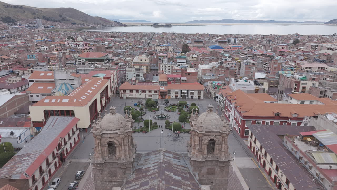 Drone shot above Plaza Mayor de Puno Peru near the church or cathedral LOG