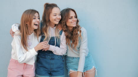 three happy friends laughing together