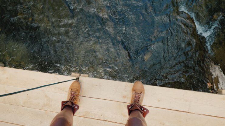Walk Along The Edge Of The Wobbly Wooden Bridge Across The River Overcome Phobias And Fear Concept P