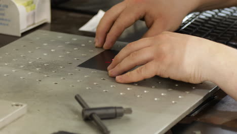 technician engineer working on precision laser inc machine inside a factory workshop