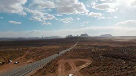 Drone-view-along-famous-sunny-American-desert-highway-road-in-Monuments-Valley-in-Arizona-and-Utah,-Forrest-Gump-point-in-april