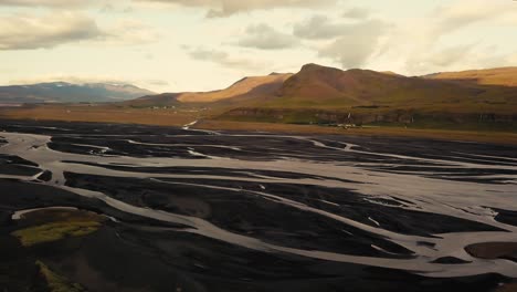 Various-shots-by-drone-of-an-icelandic-glacial-river-in-beautiful-sunset-light