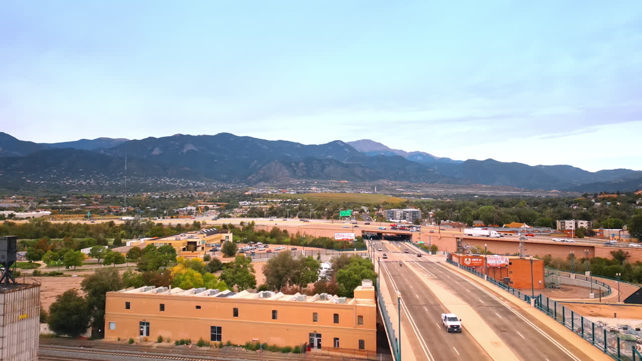 Colorado Springs, USA, 22 July 2025: Cars run quickly by the roads of Colorado-Springs, Colorado, USA. Aerial perspective on the low-rise city surrounded by the mountains