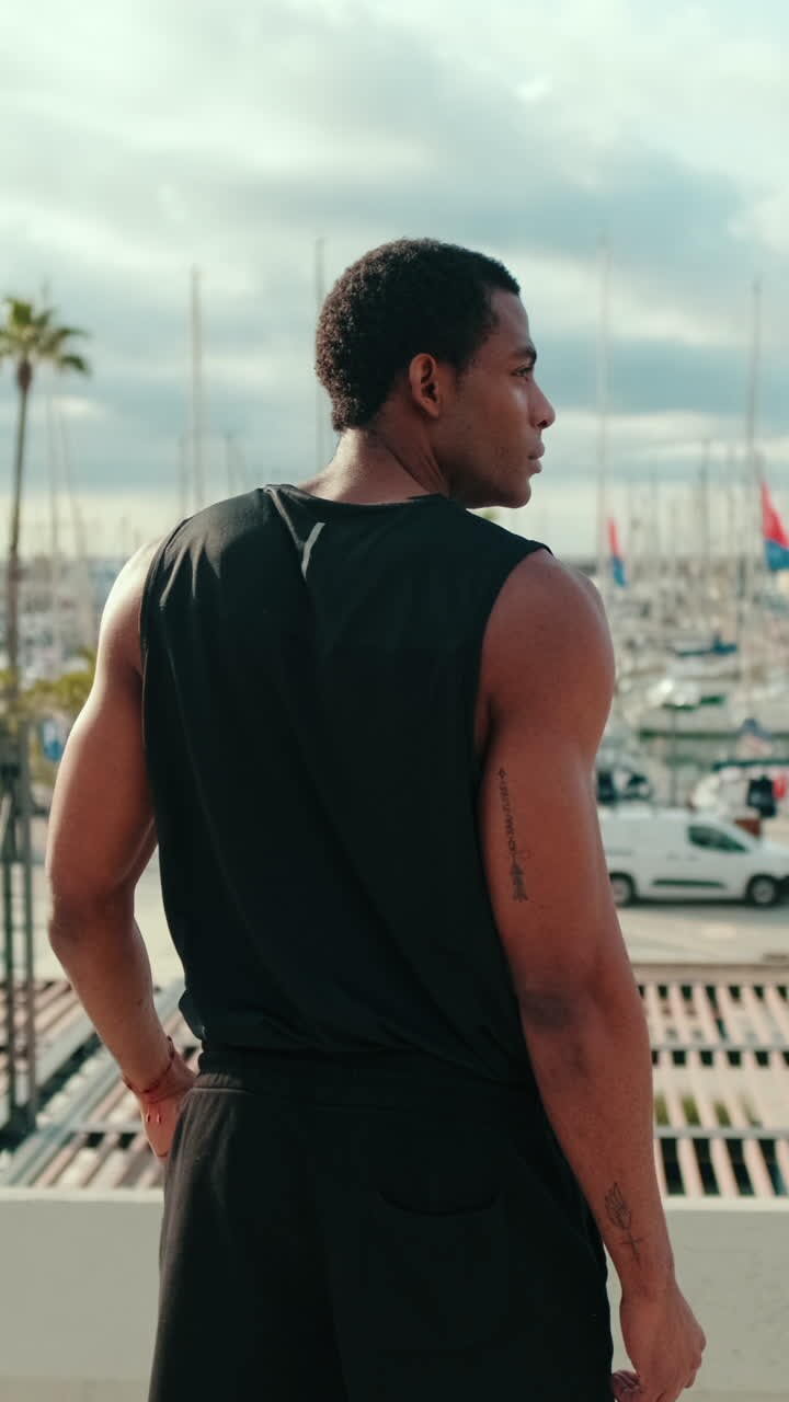 Athlete Overlooking a Harbor Full of Sailboats