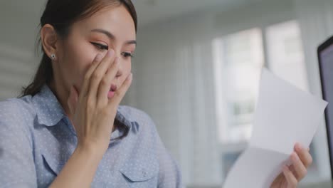 girl distant remote work upset lost after read bad news layoff letter.