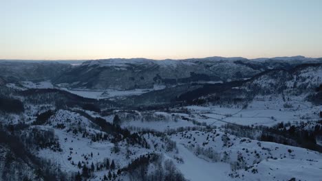 Drone-footage-of-Norwegian-landscape,-fjord-and-sunset