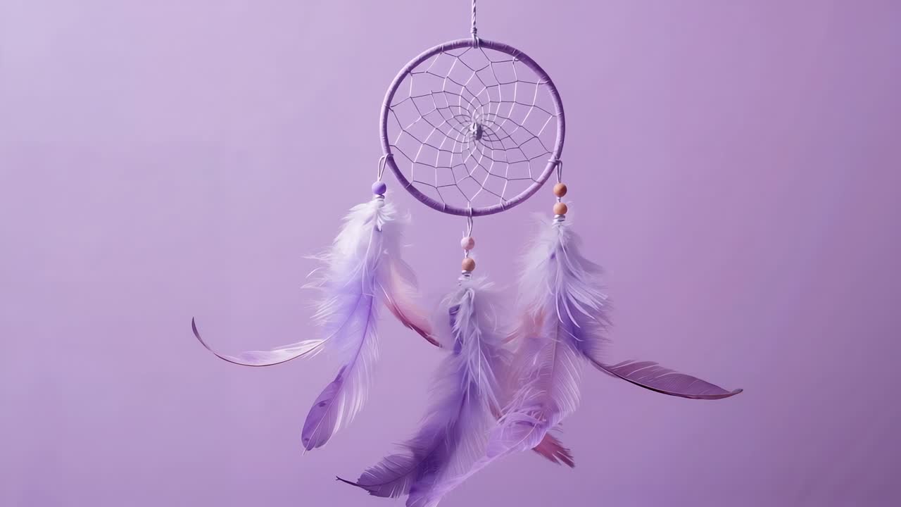 Gentle breeze causing lavender dreamcatcher hoop fluttering feathers with beads, on lilac backdrop