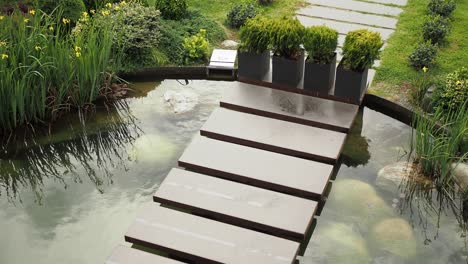 modern garden pond with stepping stones