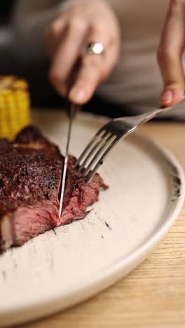 woman eating steak dinner