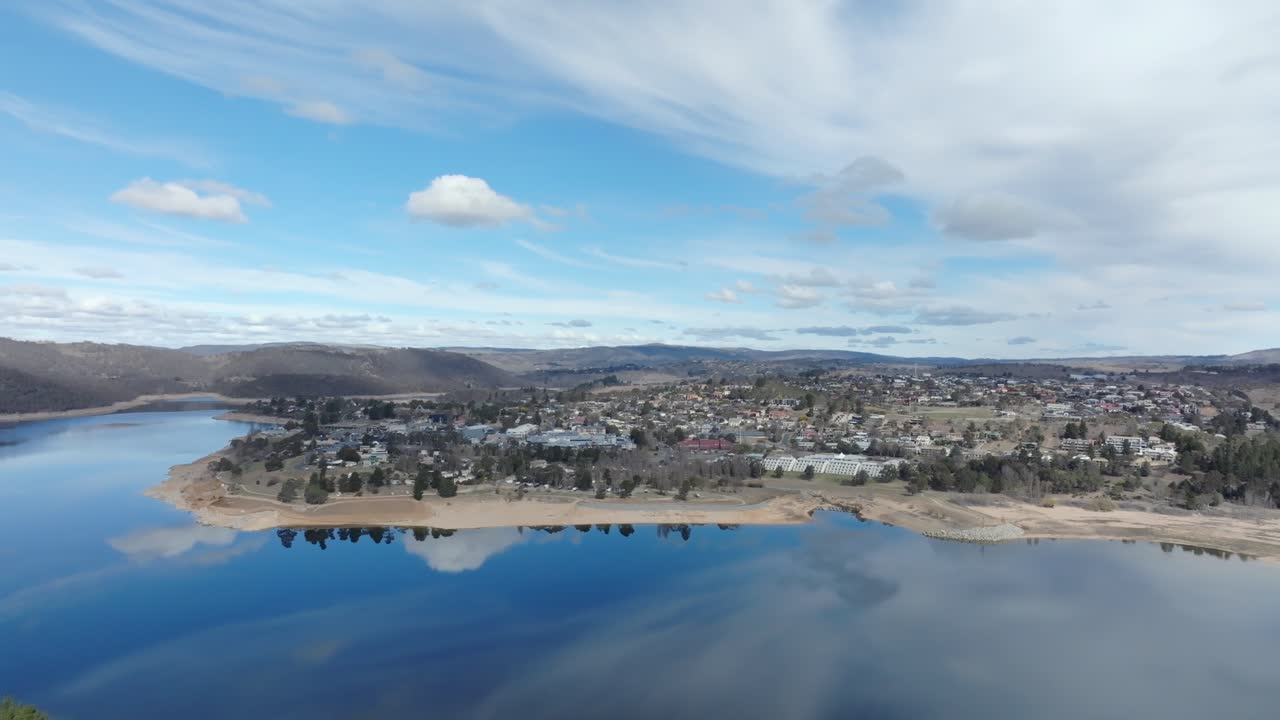 Aerial wide shot circling to the left around Jindabyne town, NSW, Australia