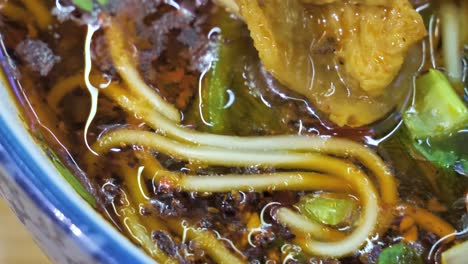 close up of delicious china spicy food, beef noodle mi xian with braised beef slices and coriander, china