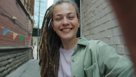 young woman video call in urban alley