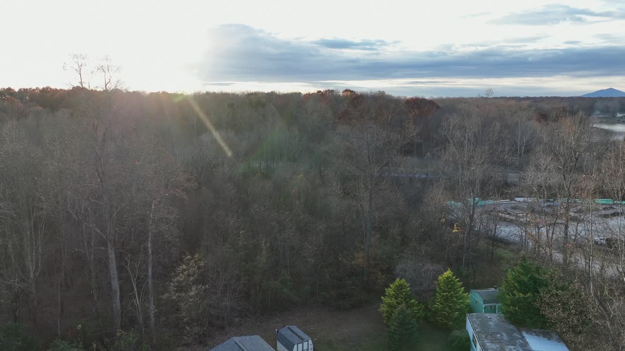 Aerial rising shot of mobile trailer homes with parking car in suburb district of american town. Parking cars on driveway in USA. Wide shot