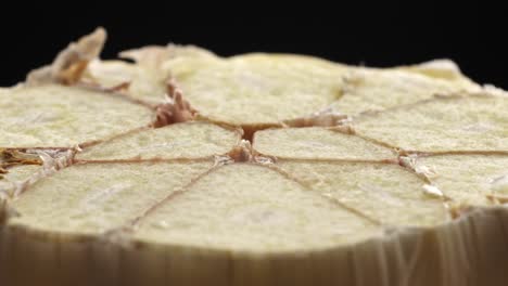 macro of garlic bulb from side angle showing internal base and natural patterns clearly after being sliced in half
