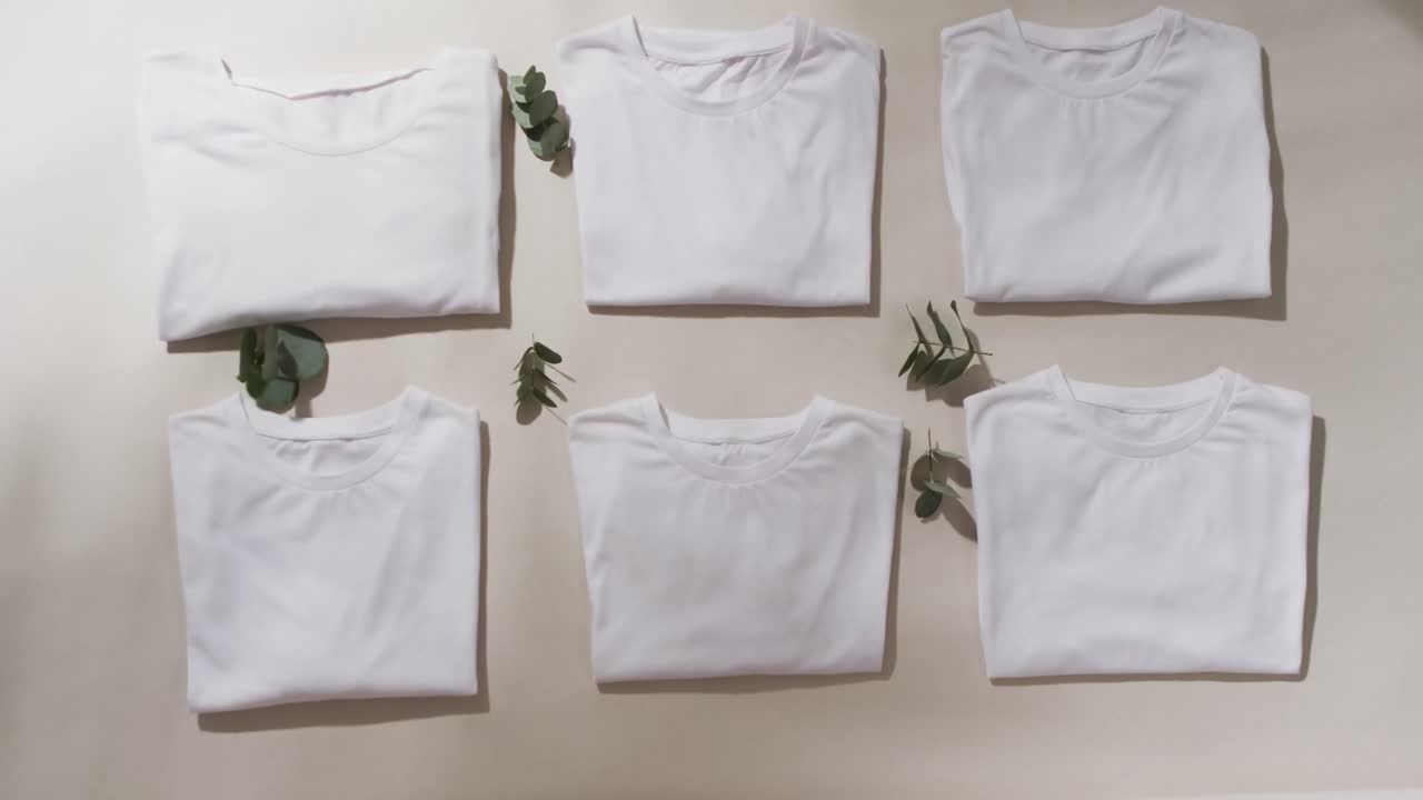 video de una capa plana de camisetas blancas plegadas con espacio de copia sobre un fondo blanco