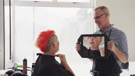 Rear-view-woman-looking-at-her-hair-final-look-in-the-mirror