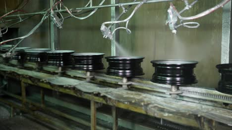 automated car wheel painting process in a factory