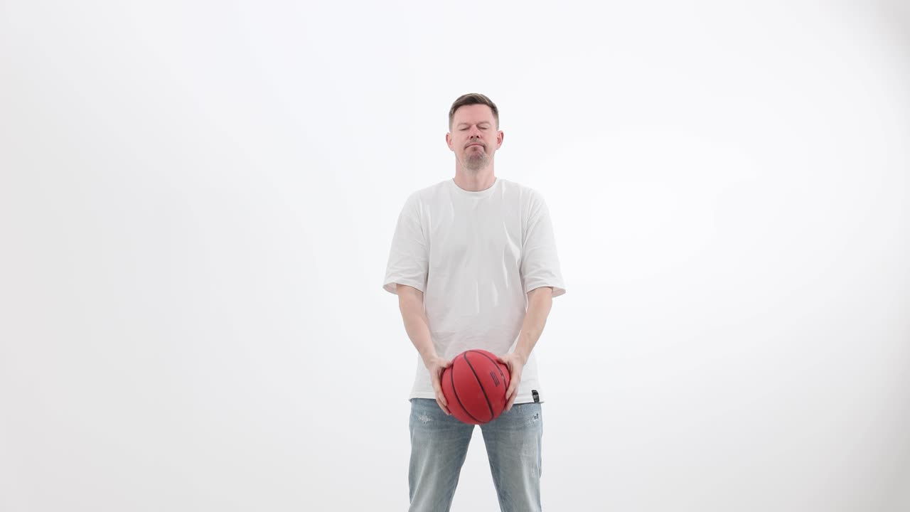 Man playing and balancing a basketball on a white background