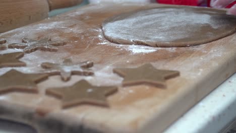 caucasian woman making gingerbread stars