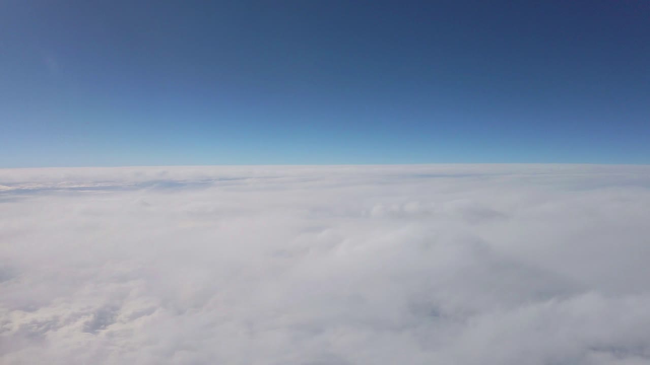 Aerial shot of thick cloud layer with blue sky