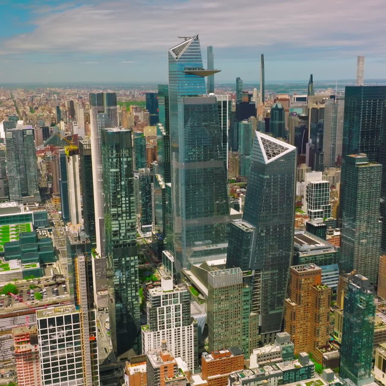 Midtown Manhattan architecture at sunny daytime. River waterfront with docks and lively traffic
