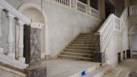 abandoned grand staircase in a historic building