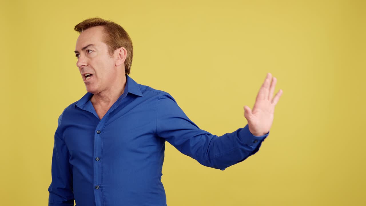 Man in blue shirt making a stop gesture with various expressions