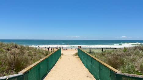 sandy path leading to a sunny beach