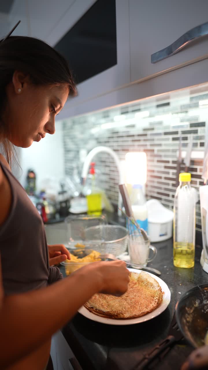 Woman cooking in the kitchen at night