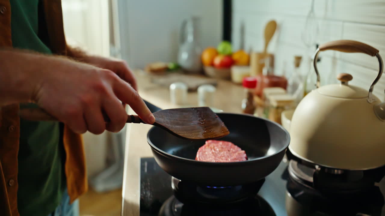 Man hands cooking steak standing domestic kitchen closeup. Male chef taking beef