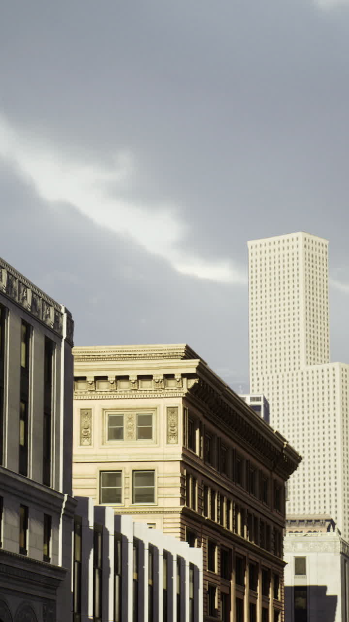 Urban skyline displays diverse architectural styles under dramatic clouds