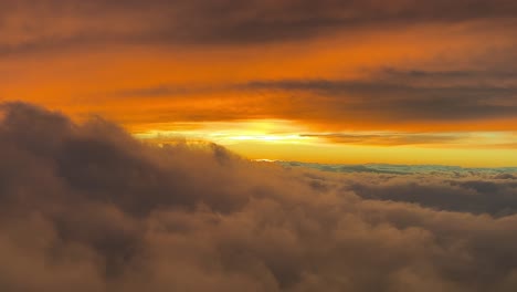 stunning view of a colorful red sunset shot from an airplane cabin while flying at sunset at 10000m high