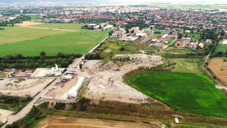 Aerial-drone-view-of-open-landfill-site-with-piles-of-waste