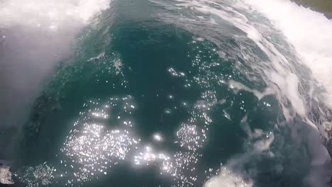 close up shot from underneath a boat over the water. french polynesia