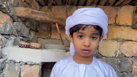 arab kid in arabian traditional house made with stone
