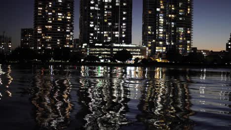 city lights reflecting on river at night