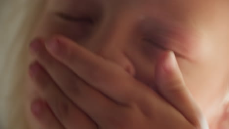close up of a sneezing young girl