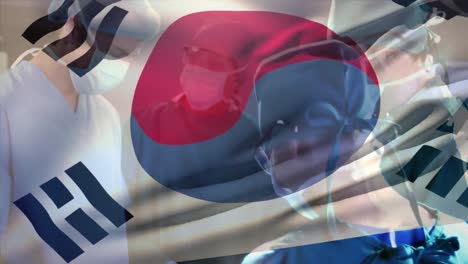 Animation-of-flag-of-south-korea-over-diverse-surgeons-with-face-masks-during-surgery